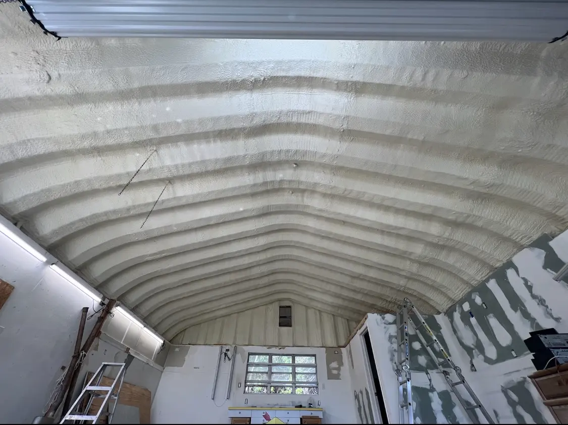 Spray polyurethane foam applied to the underside of a metal roof deck in New London
